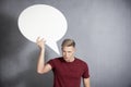 Angry man holding white empty speech ballon. Royalty Free Stock Photo