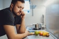 Angry man leaning on a kitchen countertop Royalty Free Stock Photo