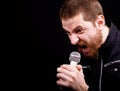 Angry man and loud scream at microphone Royalty Free Stock Photo