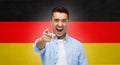 Angry man pointing finger on you over german flag Royalty Free Stock Photo