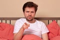 Angry man pointing his finger at you sitting in the bed at home Royalty Free Stock Photo