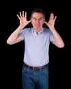 Angry Man Poking Out Tongue with Hands in Ears Royalty Free Stock Photo