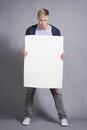 Angry man presenting white blank panel. Royalty Free Stock Photo