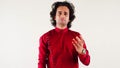 Angry man in a red shirt persuade someone with a hand gesture posing against a white background