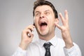 Angry man screaming on client by phone. Aggressive boss calling employee who didn`t finish his work on time. Royalty Free Stock Photo