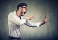 Angry man shouting at phone in hands Royalty Free Stock Photo