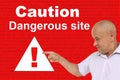 Angry man shows an exclamation mark on a triangle, concept attention on a red technological background, concept Deceptive site