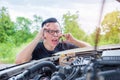 Angry man sitting beside a broken car calling for assistance Royalty Free Stock Photo