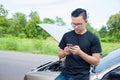 Angry man sitting on a broken car calling for assistance Royalty Free Stock Photo