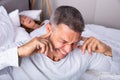 An Angry Man With Snoring Wife On Bed Royalty Free Stock Photo