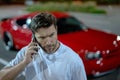 Angry man talking on phone on night urban street. Dangerous aggressive man talking on phone with serious face. Criminal Royalty Free Stock Photo