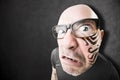 Angry man with tattoo on his face Royalty Free Stock Photo