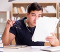 Angry man with too much paperwork to do Royalty Free Stock Photo