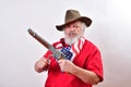 Angry man wearing patriotic colors cocking his short rifle Royalty Free Stock Photo