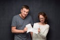 Angry man and woman are tearing paper sheet Royalty Free Stock Photo