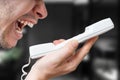 Angry man is yelling in phone Royalty Free Stock Photo