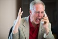 Angry man yelling on the phone Royalty Free Stock Photo