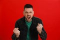 Angry man yelling on red background. Hate concept Royalty Free Stock Photo