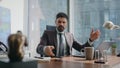 Angry manager throwing telephone on work desk nervous about phone conversation. Royalty Free Stock Photo