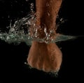 Angry mans fist punching water. Human power energy in water Royalty Free Stock Photo