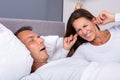 Woman Blocking Ears With Fingers While Husband Snoring Royalty Free Stock Photo
