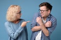 Angry mature woman shouting, blaming millennial annoyed son in eyeglasses. Royalty Free Stock Photo