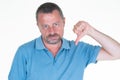 Angry middle age man doing dislike thumb down gesture over isolated white background Royalty Free Stock Photo