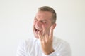 Angry middle-aged man making a Horns gesture Royalty Free Stock Photo