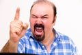 Angry middle-aged man screaming and threatening