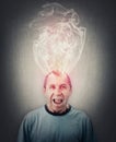 Angry middle aged man screaming and yelling, mind is boiling as dense steam comes out of his head. Fatigue and annoyed senior male Royalty Free Stock Photo