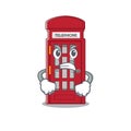 Angry miniature telephone booth above cartoon table Royalty Free Stock Photo