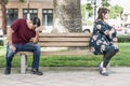 Angry Mixed Race Couple Sitting Facing Away From Each Other on Park Bench