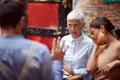 Angry mother in law looking reproachfully  her son-in-law who is justifying. her daughter sitting beside with her hand on a face, Royalty Free Stock Photo