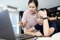 Angry mother scolding her daughter about an education on computer,stressed student suffers from displeasure of female tutor or