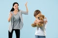 Angry mother scolding her son in living room at home Royalty Free Stock Photo