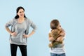 Angry mother scolding her son in living room at home Royalty Free Stock Photo