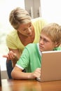 Angry Mother And Teenage Son Using Laptop At Home Royalty Free Stock Photo