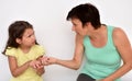 Angry mother trying to take smartphone from hands of her daughter