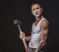 Angry muscular man with hammer