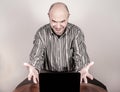 Angry and nervous businessman with a laptop Royalty Free Stock Photo