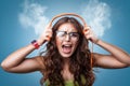 Angry nervous girl in headphones listening to music Royalty Free Stock Photo