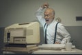 Angry office worker hitting his outdated computer Royalty Free Stock Photo