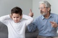 Angry old grandpa shouting at grandson close ears ignore grandfather