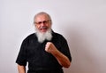 Angry old man making a threatening gesture with his fist Royalty Free Stock Photo