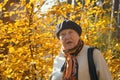 Angry old woman feels the outrage in autumn park