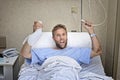 Angry patient man at hospital room lying in bed pressing nurse call button holding potty