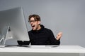 Angry programmer in eyeglasses screaming near