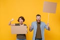 Angry protesting people guy girl hold protest signs broadsheet blank placard on stick isolated on yellow background