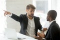 Rude white partner telling black businessman get out his office