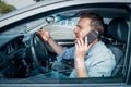 Angry and rude man driving his car feeling stressed talking on the phone Royalty Free Stock Photo